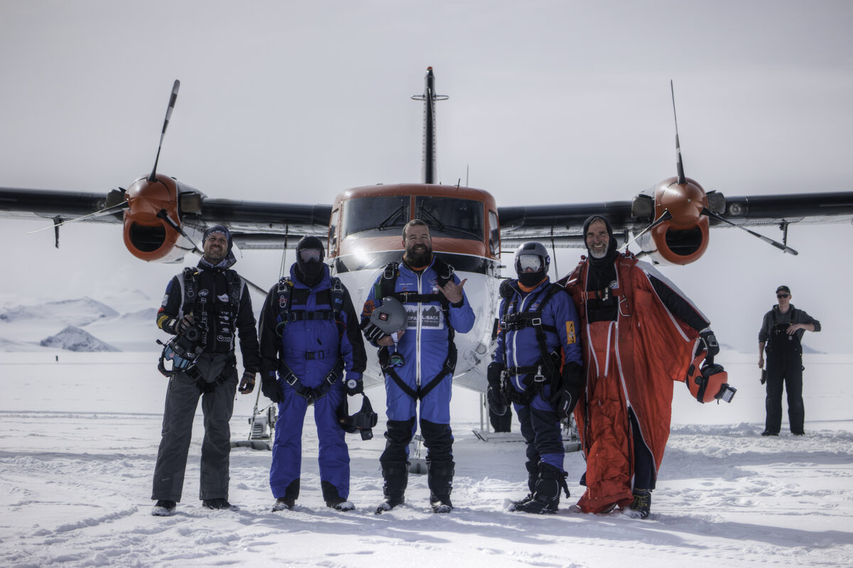 Skydive Antarctica guests pose for a photo in front of the Twin Otter