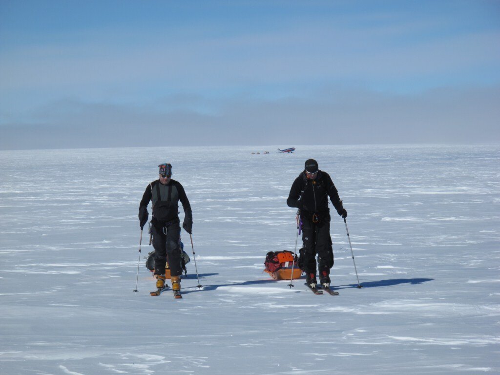 Climbers set off from base camp with skis and sleds